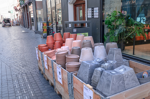 Various flower pots for sale in the city street near the shop. Copenhagen, Denmark - August 3, 2023.