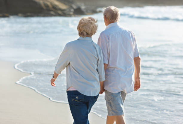 istock Elderly couple strolling around at the beach 157602205