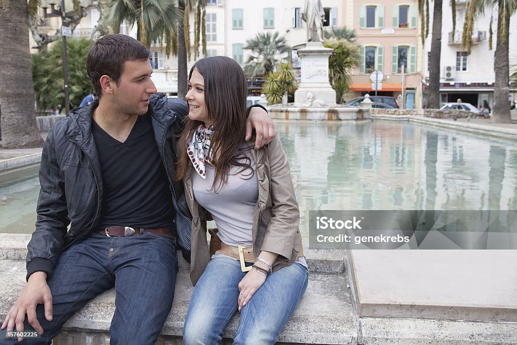 Young Couple Sitting next to a reflecting pool 20-24 Years Stock Photo