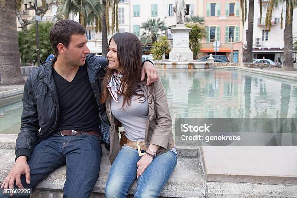Young Couple Sitting Next To A Reflecting Pool Stock Photo - Download Image Now - 20-24 Years, Adult, Adults Only