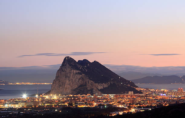 The Rock of Gibraltar The Rock of Gibraltar and spanish town La Linea at night gibraltar photos stock pictures, royalty-free photos & images