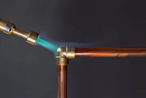 Photo of Gas flame heating copper piping