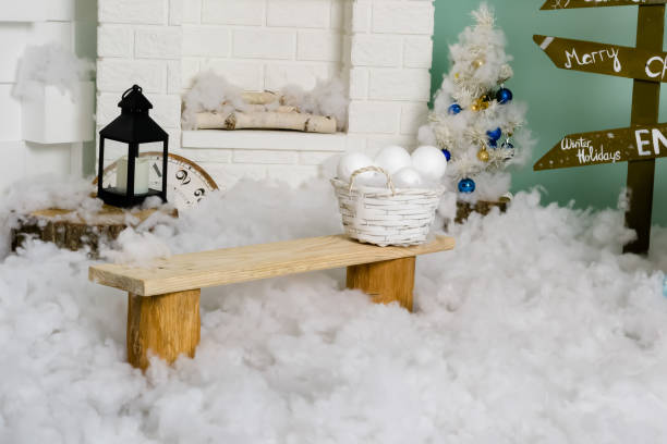 istock Winter New Year interior. Fireplace. lantern, bench, snow balls, Christmas tree with balls. Cozy decor in white tones in the interior of the Christmas room, a Christmas tree decorated with garlands, gifts. A festive living room in the house. New Year's h 1576028170