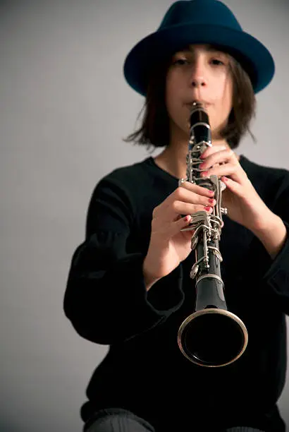 Teenager playing the clarinet, close up