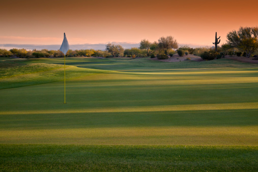 Sunrise on a Scottsdale Arizona Resort and Golf Course with dramatic mood lighting ...