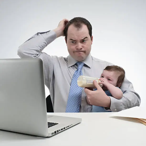 Photo of Frustrated Father Multi-Tasking