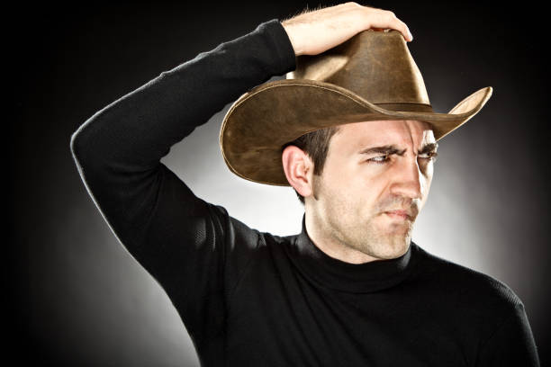 istock man with coyboy hat portrait on grey background 157603540