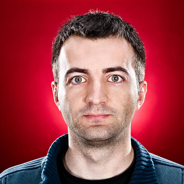 istock very tired man portrait on red background 157603584