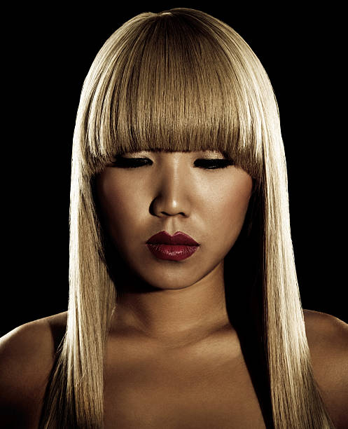 Sepia-toned Portrait of Asian Woman with Long Blonde Hair stock photo
