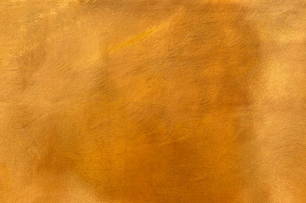 Golden brass metal plate background textured surface XL Brushed brown-golden copper or bronze surface, with visible brush strokes. The sheet metal has an appealing cloudy, wavy texture. Horizontal orientation. The image has been shot outdoors during natural day light, full frame and close up. Ideal for backgrounds. The dimensions of the photo are 4223 x 2805 px. High resolution. brass stock pictures, royalty-free photos & images