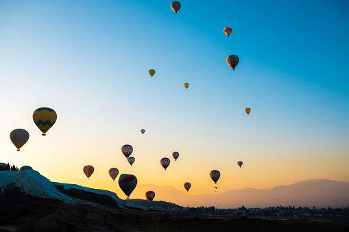 Tranquil Morning in Pamukkale: Hot Air Balloons and Majestic Mountains