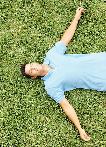 istock Top view of a young man relaxing on grass 157605556