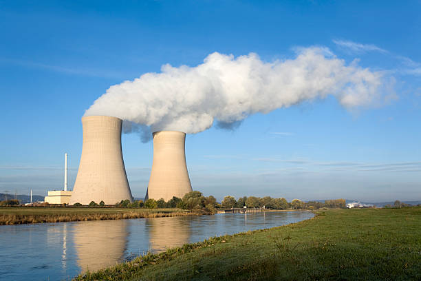 istock Nuclear power station with two steaming cooling towers riverside (XXXL) 157605601