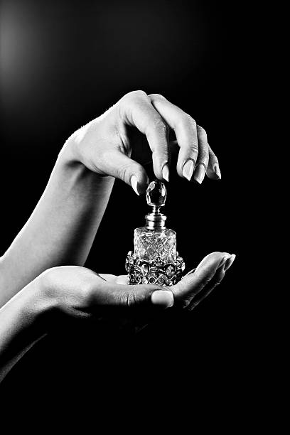 beautiful hands and luxury perfume bottle beautiful hands on black... perfume sprayer photos stock pictures, royalty-free photos & images