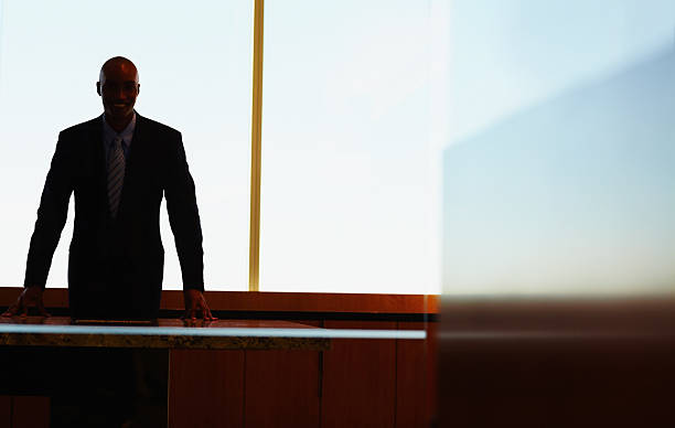 istock Business man standing against glass window 157606009