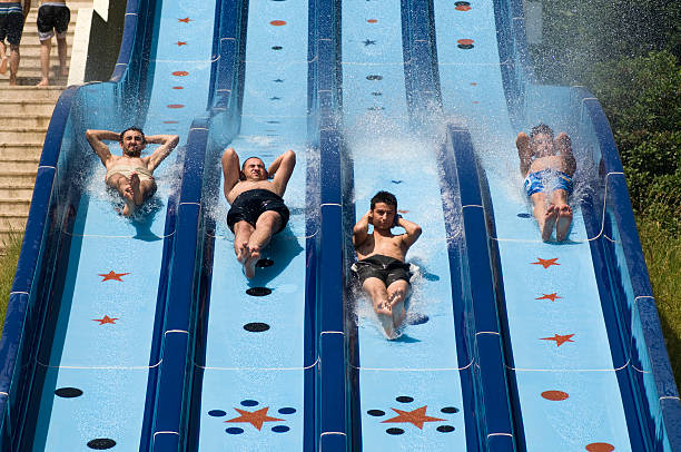 istock Four boys racing down the water slide 157606225