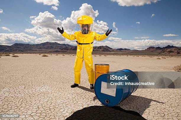Man In Hazmat Suit Upset Over An Oil Spill Stock Photo - Download Image Now - Oil Spill, Radiation Protection Suit, Spilling