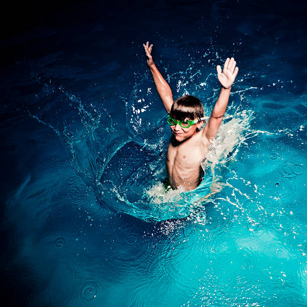 kid jumping in a pool, having lots of fun, square format