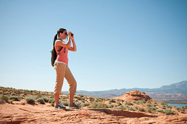 istock Young woman on a hiking trip with binoculars 157606538