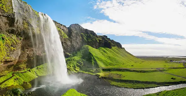 Waterfall and landscape like in a dream, the Seljalandsfoss in Iceland.