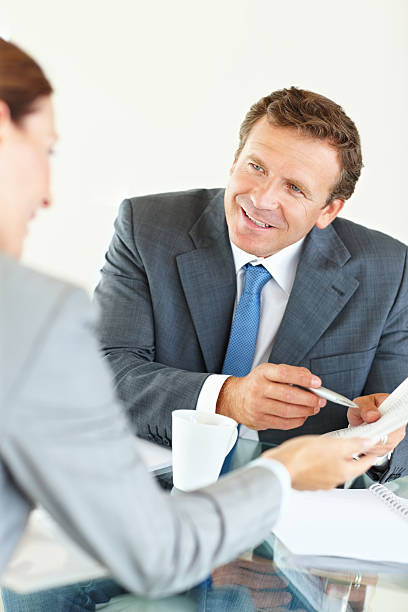 istock Smiling businessman discussing with his colleague 157606848