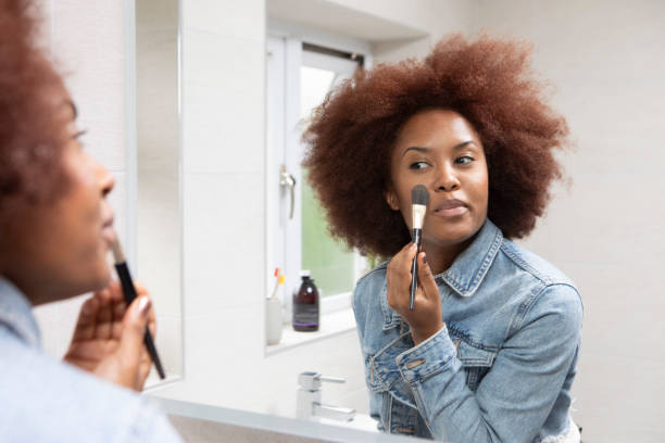 istock Young woman getting ready in front of a bathroom mirror 1576071823