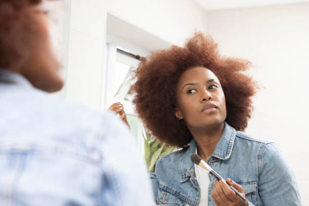 istock Young woman getting ready in front of a bathroom mirror 1576072339