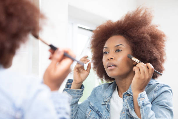 istock Young woman getting ready in front of a bathroom mirror 1576072350