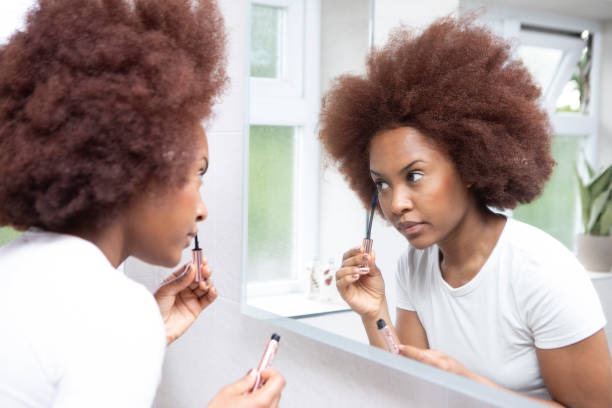 istock Young woman getting ready in front of a bathroom mirror 1576072873