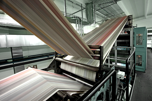 Paper passing through a web offset machine in an italian newspapers printing press. Other images in: