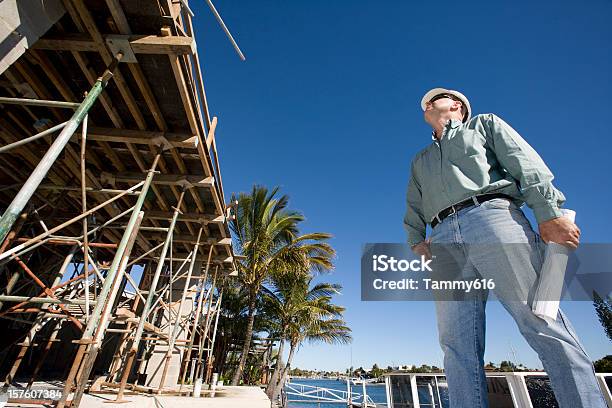 Man At Work Looking At A Construction Site Stock Photo - Download Image Now - Construction Site, Palm Tree, Construction Industry