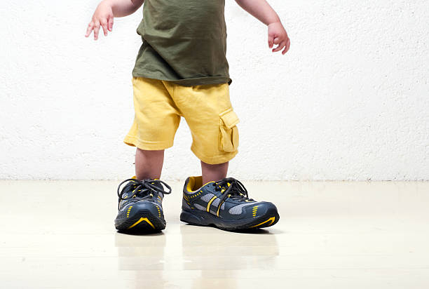 Little boy in big shoes.