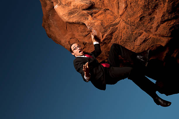 istock Business man Falling Off Of Rock Ledge 157607451
