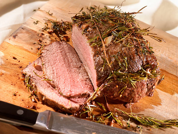 istock Roast Beef with Rosemary on a Cutting Board 157607456