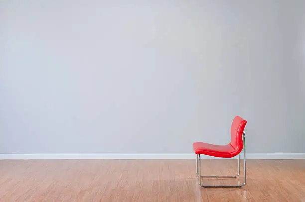 Photo of Retro Red Chair In Empty Room
