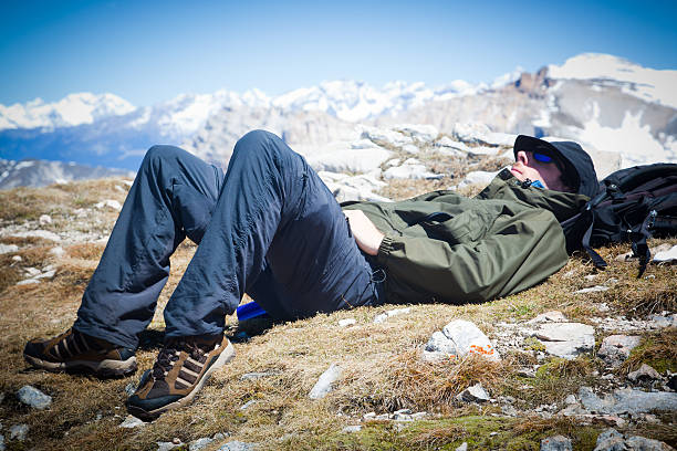 Man resting in a mountain landscape. Location: Italian Alps, Dolomites.