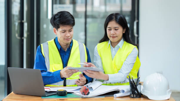 istock Civil engineers and architects discuss project construction together at office 1576076624