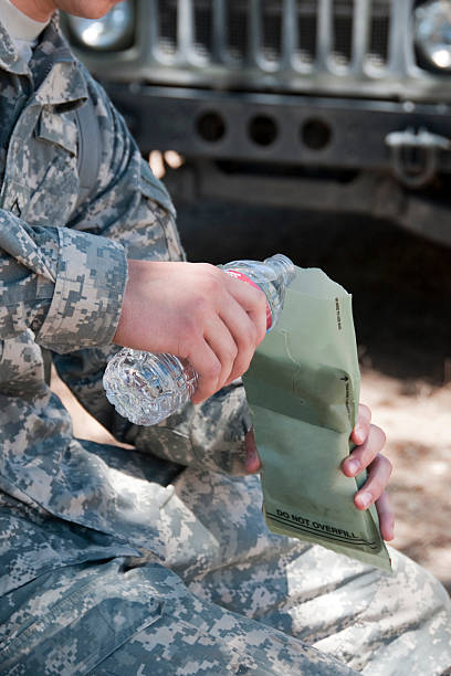 soldier preparing field rations stock photo