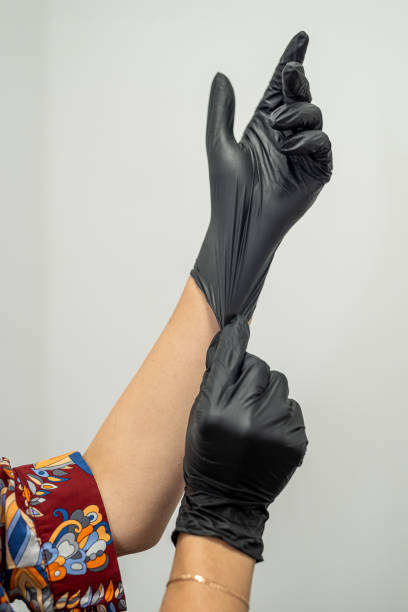 istock depilation master puts on gloves before the procedure. 1576078834