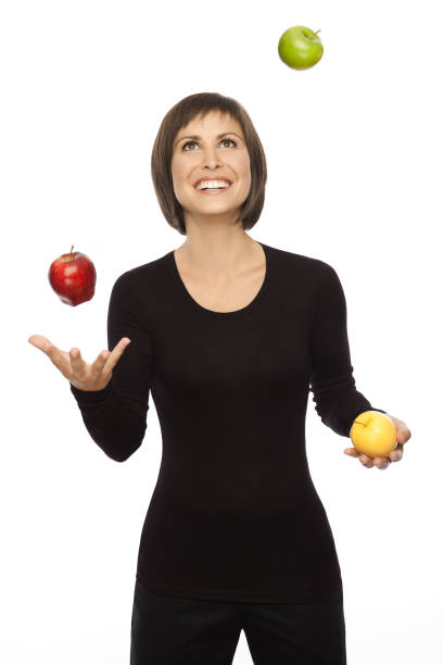 istock Beautiful woman Juggling With Three Apples 157607908