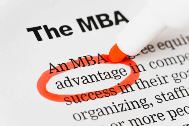 Photo of Red pen circles "advantage" in document headed MBA.