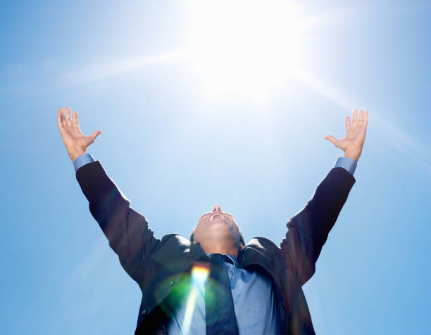 istock Business man with hands outstretched against blue sky 157608130