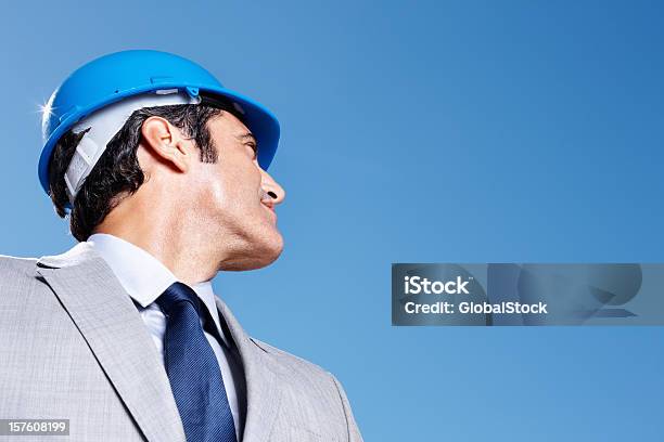 Business Man Wearing A Helmet And Looking At Copy Space Stock Photo - Download Image Now