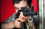 Man aiming with assault rifle AK-47