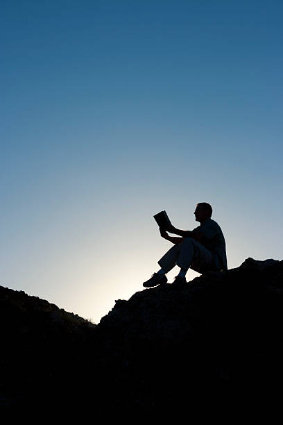 istock Silhouette of man reading 157608418