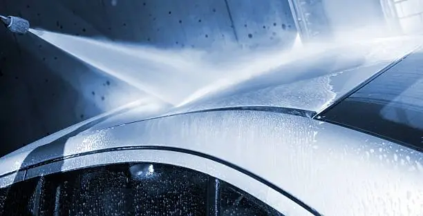 Photo of Car wash - with a water jet at carwash service