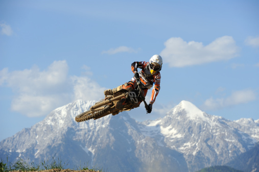 Motorbiker riding his motorbike on the motocross road in nature. Slovakia