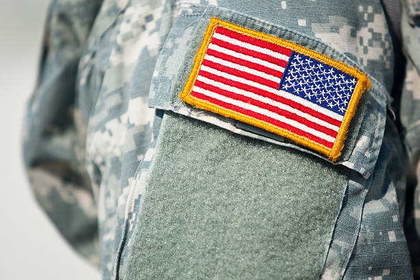 Proud to be an American American Flag on the shoulder of a uniformed American soldier national guard stock pictures, royalty-free photos & images