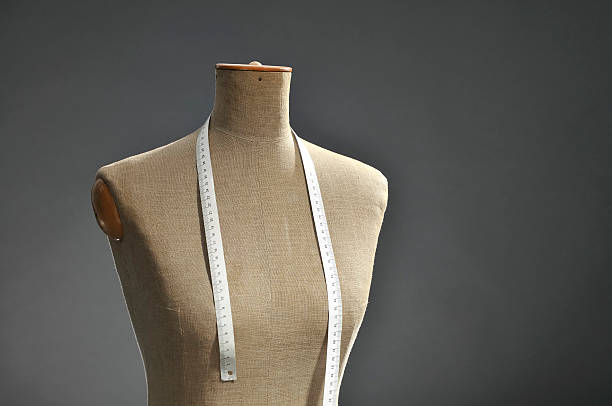 istock Retro female tailor's mannequin torso with measuring tape, dark background 157609346
