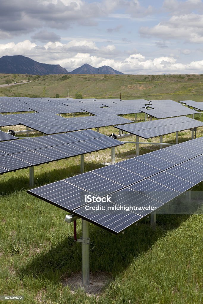 rows-of-solar-panels-and-rocky-mountains-colorado-stock-photo